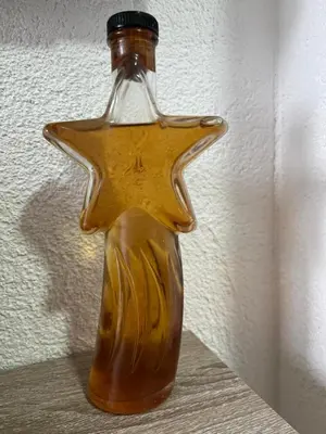 a glass bottle shaped like a star sitting on a shelf at Lutovac Apartmani in Kotor