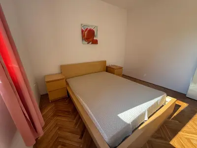 a small bedroom with a bed in a room at La Marea in Petrovac na Moru