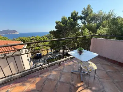a white table and a chair on a balcony at La Marea in Petrovac na Moru