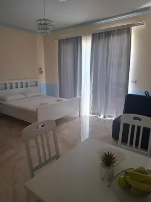 a bedroom with a bed and a table and chairs at Apartments Sophia in Ulcinj