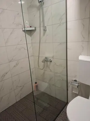 a bathroom with a glass shower with a toilet at Apartments Sophia in Ulcinj