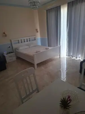 a bedroom with a bed and a table and chairs at Apartments Sophia in Ulcinj