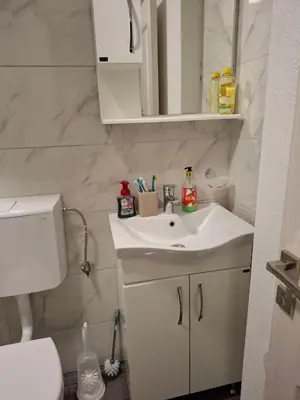 a white bathroom with a sink and a toilet at Apartments Sophia in Ulcinj
