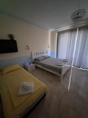 a bedroom with two beds and a large window at Apartments Sophia in Ulcinj