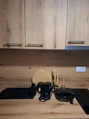 a kitchen counter with utensils on a wooden counter top at Apartments Sophia in Ulcinj