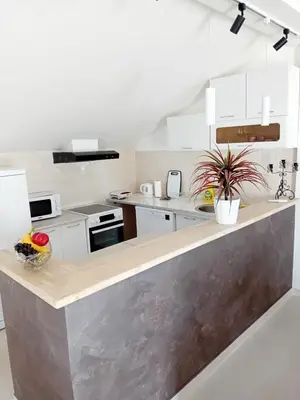 a kitchen with white cabinets and a counter top at Teodora Apartment in Kotor