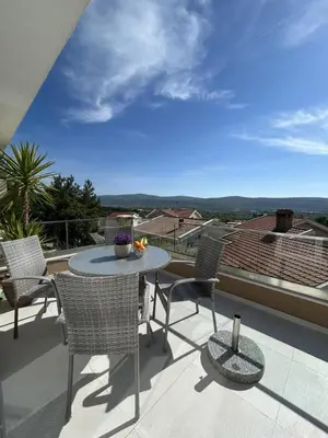 a patio with a table and chairs on a balcony at Teodora Apartment in Kotor