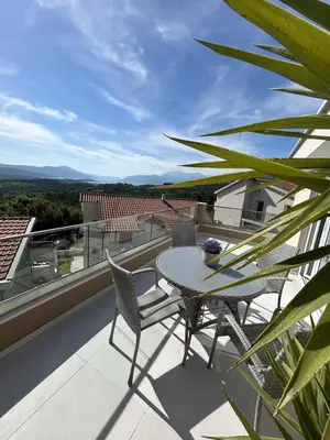 a patio with a table and chairs on a balcony at Teodora Apartment in Kotor