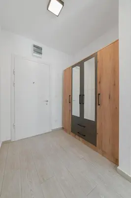 an empty room with a door and a wooden floor at MM Apartments Brown in Budva