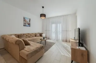 a living room with a couch and a tv at MM Apartments Brown in Budva
