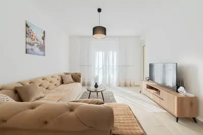a living room with a couch and a tv at MM Apartments Gray in Budva