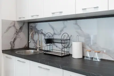 a kitchen with a sink and a counter top with a counter at MM Apartments Gray in Budva