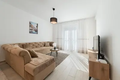 a living room with a couch and a tv at MM Apartments Gray in Budva