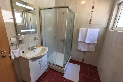 a bathroom with a shower and a sink at Berg Apartments in Bar