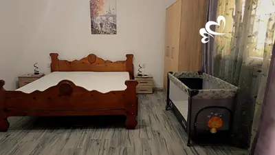 a bedroom with a bed and a crib in it at Apartman Jelena in Kotor