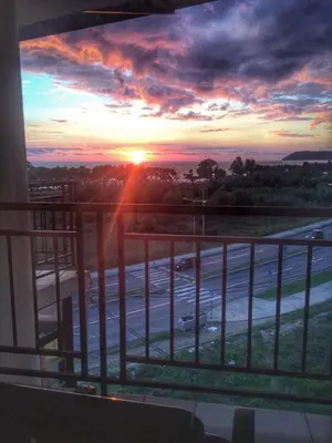 a view of a sunset from a balcony at Apartment Susanj in Bar