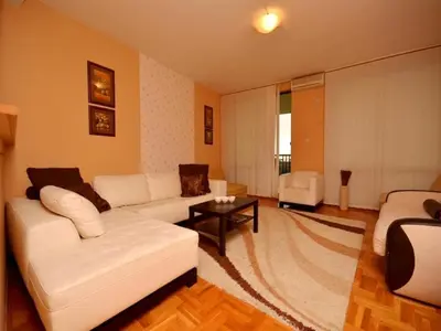 a living room with a white couch and a table at Apartment Susanj in Bar