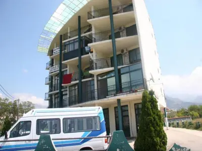 a van parked in front of a building at Apartment Susanj in Bar