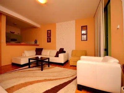 a living room with two white couches and a table at Apartment Susanj in Bar