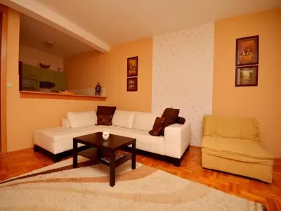 a living room with a white couch and a table at Apartment Susanj in Bar