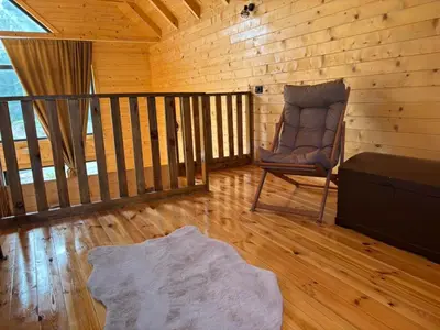a room with a rocking chair in a cabin at Driftwood Dreams in Cetinje