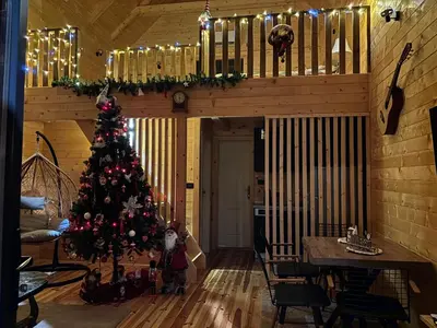 a christmas tree in a room with a dining table at Driftwood Dreams in Cetinje