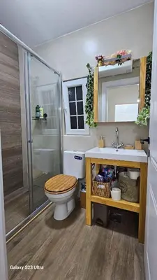 a bathroom with a toilet and a sink and a shower at LU House in Virpazar
