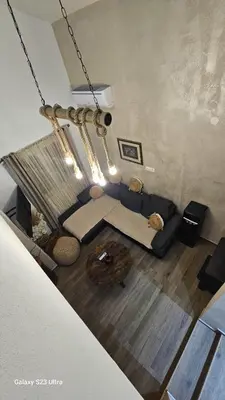 a living room with a couch and a table at LU House in Virpazar