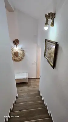 a hallway with a staircase with a picture on the wall at LU House in Virpazar