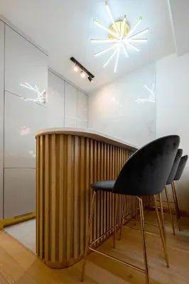 a black chair and a table in a room at URBAN-Soho City Complex in Bar