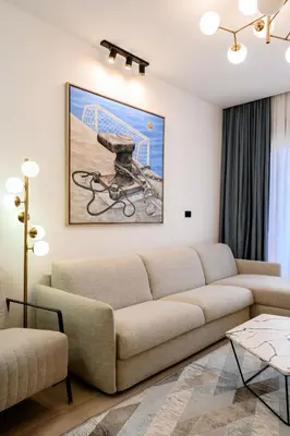a living room with a couch and a painting on the wall at URBAN-Soho City Complex in Bar