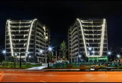 two tall buildings at night with street lights at URBAN-Soho City Complex in Bar
