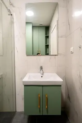 a bathroom with a green sink and a mirror at URBAN-Soho City Complex in Bar