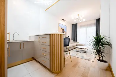a kitchen and living room with a sink and a counter at URBAN-Soho City Complex in Bar