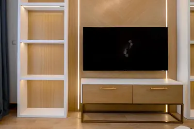 a living room with a tv and a entertainment center at URBAN-Soho City Complex in Bar