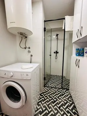 a bathroom with a washing machine and a shower at 2 Charming Apartment in Kotor Old Town in Kotor