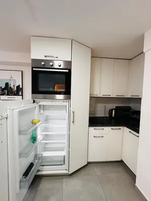 a kitchen with a white refrigerator with a microwave at 2 Charming Apartment in Kotor Old Town in Kotor