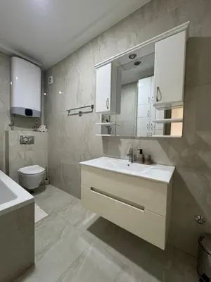 a bathroom with a sink and a toilet at Lux Apartment 14 in Kravlja
