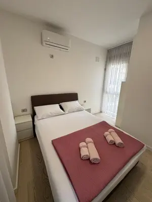 a bedroom with a bed with two towels on it at Lux Apartment 14 in Kravlja