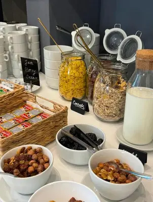 a table with bowls of food and jars of food at Lux Apartment 14 in Kravlja