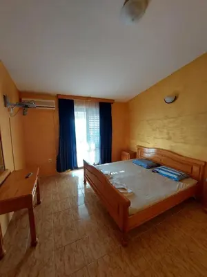 a bedroom with a large bed in a room at Vidikovac in Utjeha