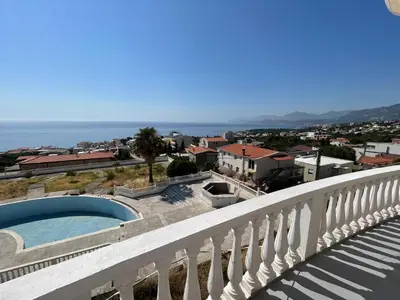 a view of a city from a balcony with a swimming pool at Vidikovac in Utjeha