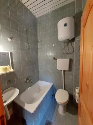 a bathroom with a tub and a toilet and a sink at Vidikovac in Utjeha