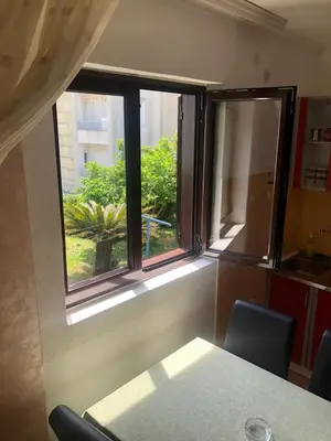 a window in a room with a table and chairs at Apartmani Centar in Petrovac na Moru
