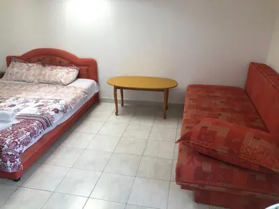 a room with a bed and a table and a couch at Apartmani Centar in Petrovac na Moru
