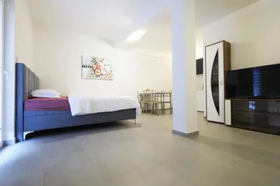 a bedroom with a bed and a flat screen tv at Status-M Apartments Seoce17 in Budva