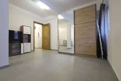 a room with a large wooden door and a television at Status-M Apartments Seoce17 in Budva
