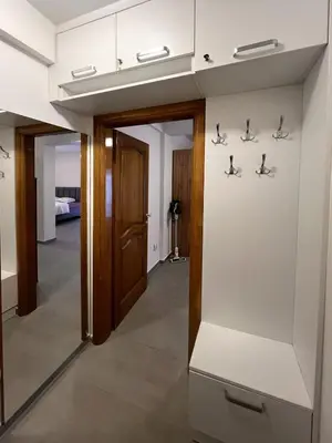 a hallway with a door and footprints on the wall at Status-M Apartments Seoce17 in Budva