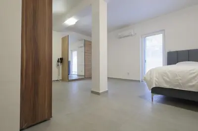 a white room with a bed and a mirror at Status-M Apartments Seoce17 in Budva