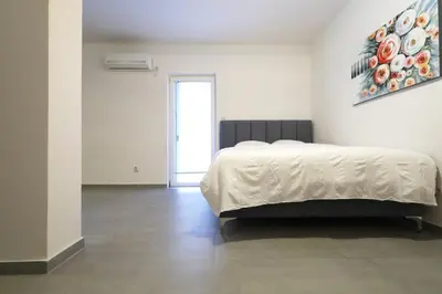 a bedroom with a bed in a white room at Status-M Apartments Seoce17 in Budva